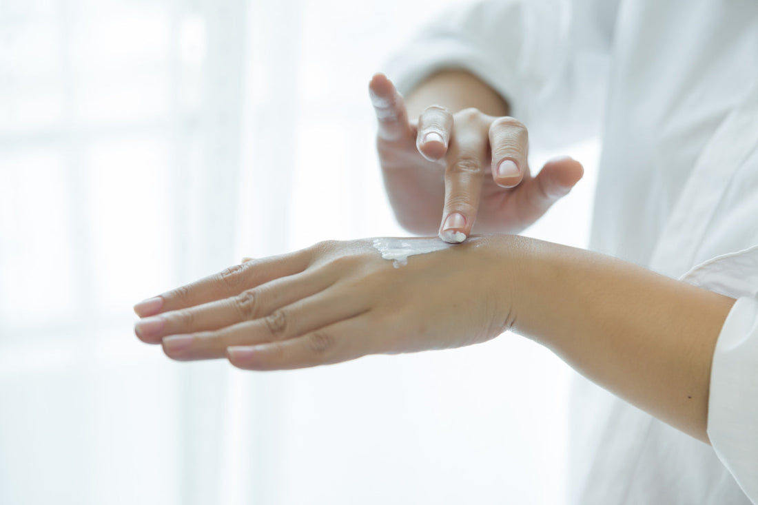 woman applying cbd topical on hands